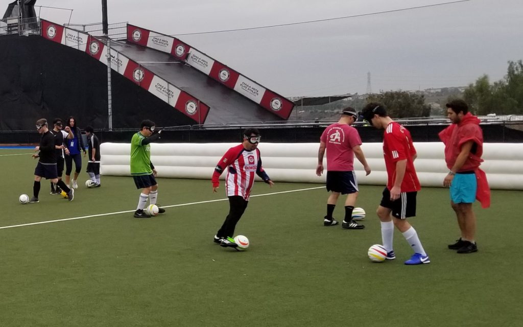 Athletes practice dribbling drills on the field with the 5-a-side soccer balls