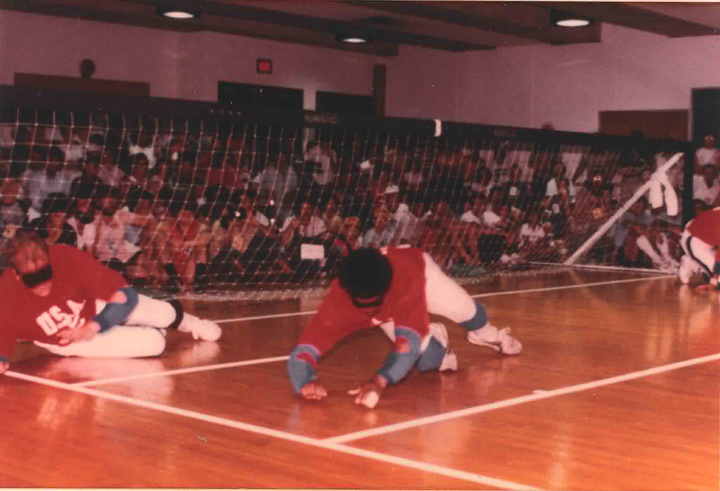 Wearing red USA jerseys, James Neppl and George Morris dive to their right as they play defense