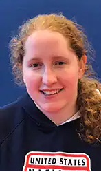 A headshot photo of Ali Lawson Trippe wearing a blue USA Goalball shirt