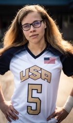 Amanda Dennis stands with her hands on her hips in her #5 USA jersey.