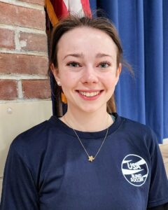 A headshot photo of Bailey Martin wearing a blue USA Blind Soccer t-shirt