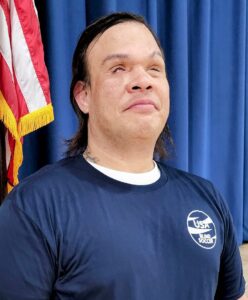 A headshot photo of Casimir Werda wearing a blue USA Blind Soccer t-shirt