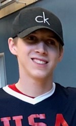 A headshot photo of Christian King wearing a baseball hat