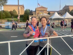 Cindy Lou Altman and Makala Wang show off their medals after the race.