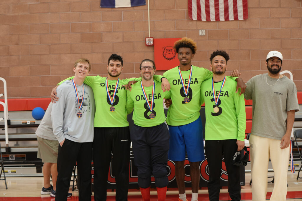 John Kusku, Tre'Shaun Faison, Hassam Itani, Adonis Watt pose in the middle of Christian King and Zion Walker who helped them earn their Gold Medal. Athletes are wearing neon green Jerseys