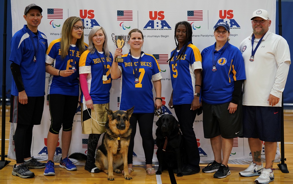 The New Jersey Honeybees pose with their gold medals and trophy.