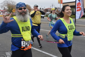 Rob Sanchas runs alongside his guide during the 2021 USABA Marathon National Championships