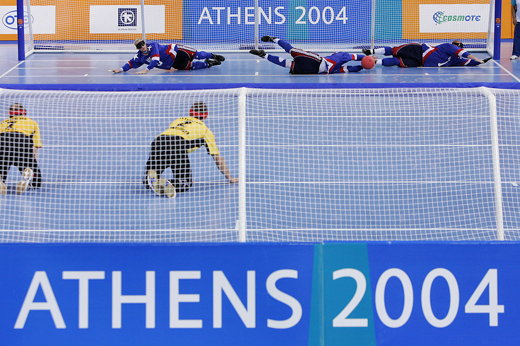 Tyler Merren stops a Germany throw with his hands flanked by wingers Eddie Munro and John Mulhern.