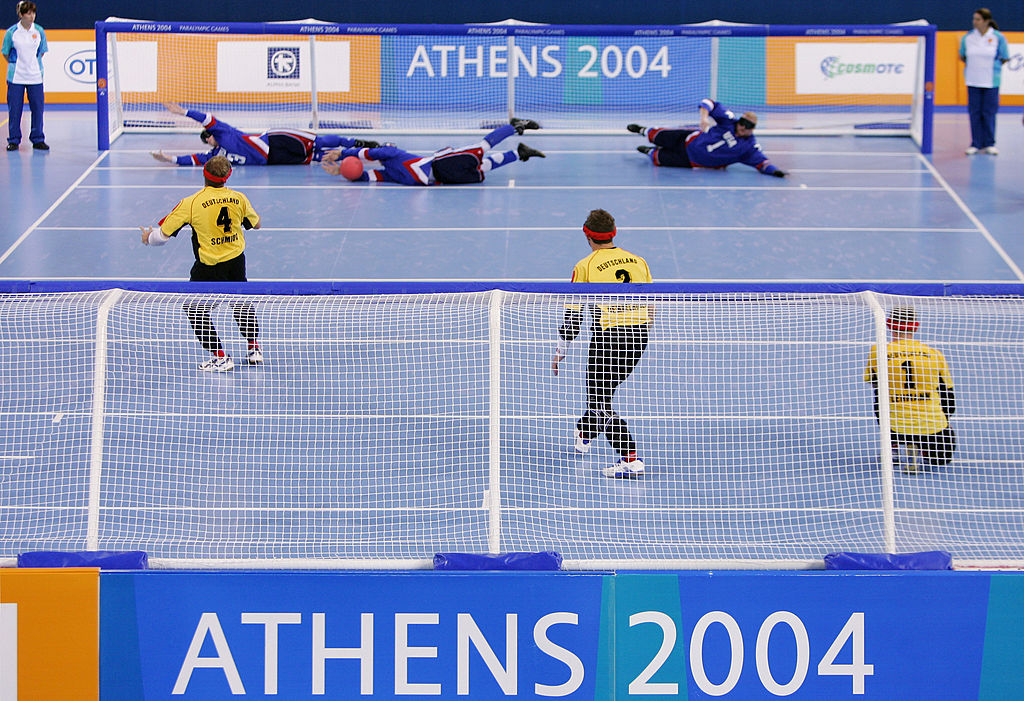 Tyler Merren stops a Germany throw with his hands flanked by wingers Eddie Munro and John Mulhern.