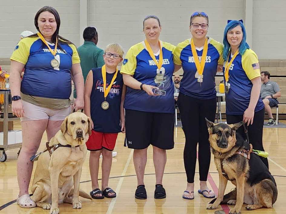 The New Jersey Honeybees pose on the court wearing their gold medals.