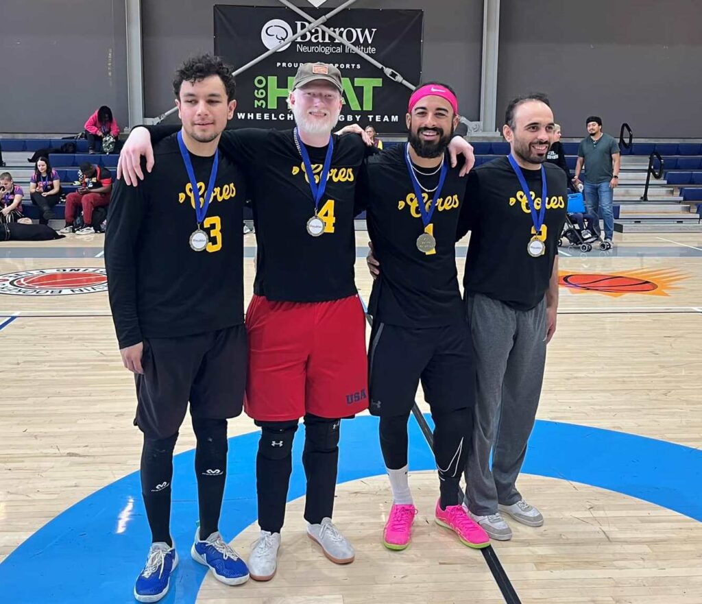 The Manticores pose with their gold medals on the court.