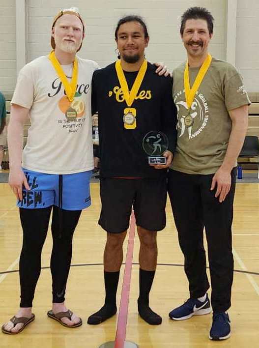 The Manticores pose on the court with their gold medals around their necks.