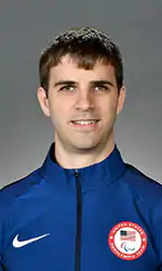 A headshot of Matt Simpson wearing a blue jacket