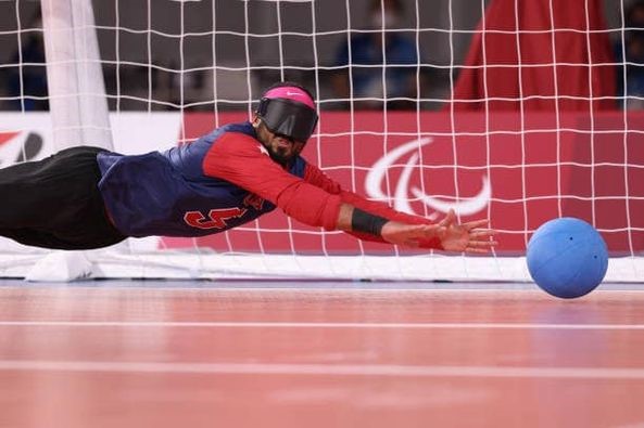 Zach Buhler dives to make a save during a goalball match at the Tokyo 2020 Paralympic Games